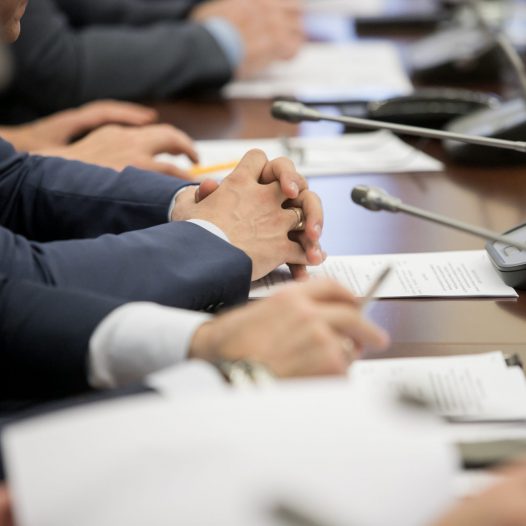 One,Of,Politician,Sitting,By,Table,With,His,Hands,Over